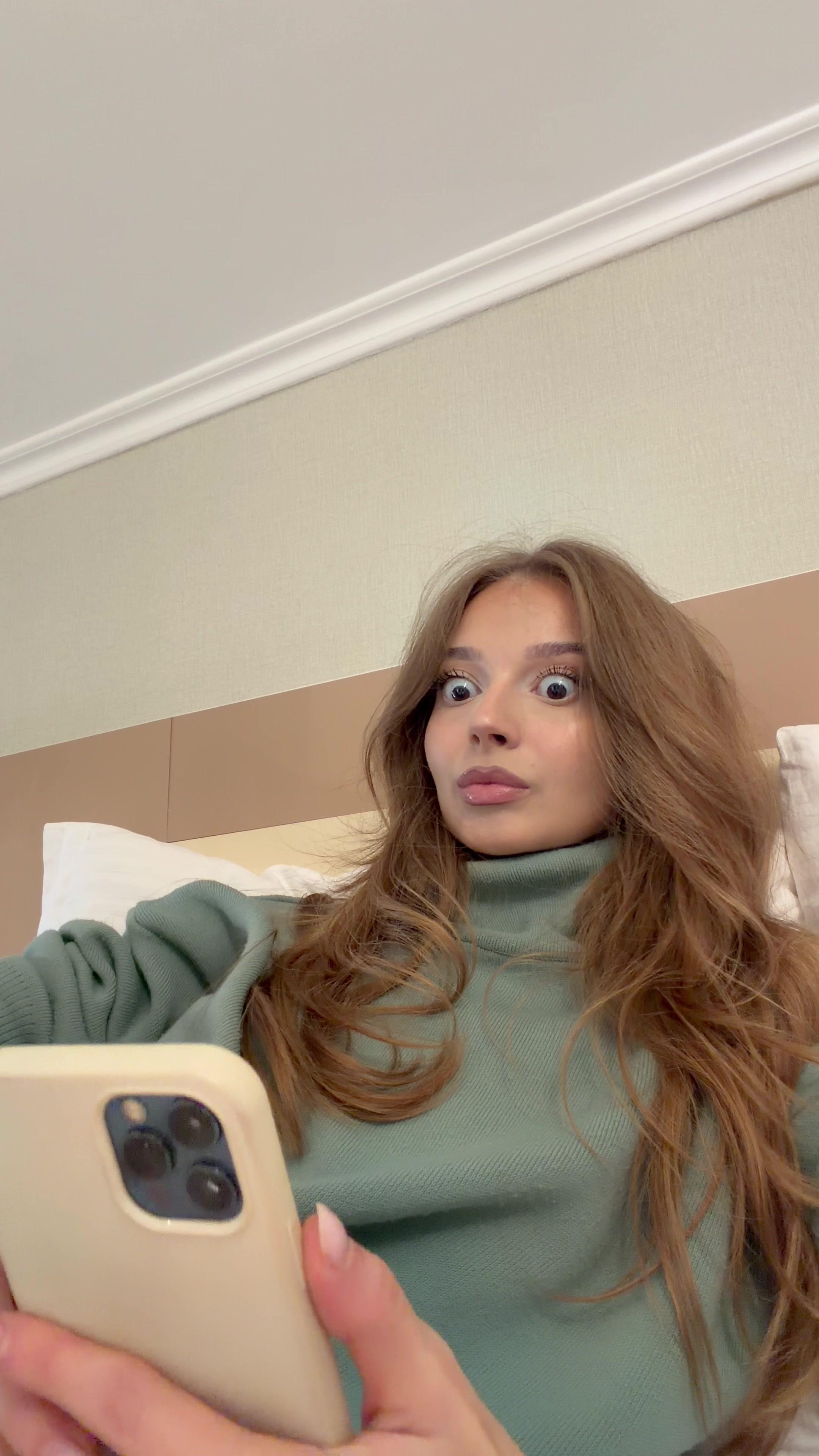 Woman Looking Shocked at Smartphone Screen