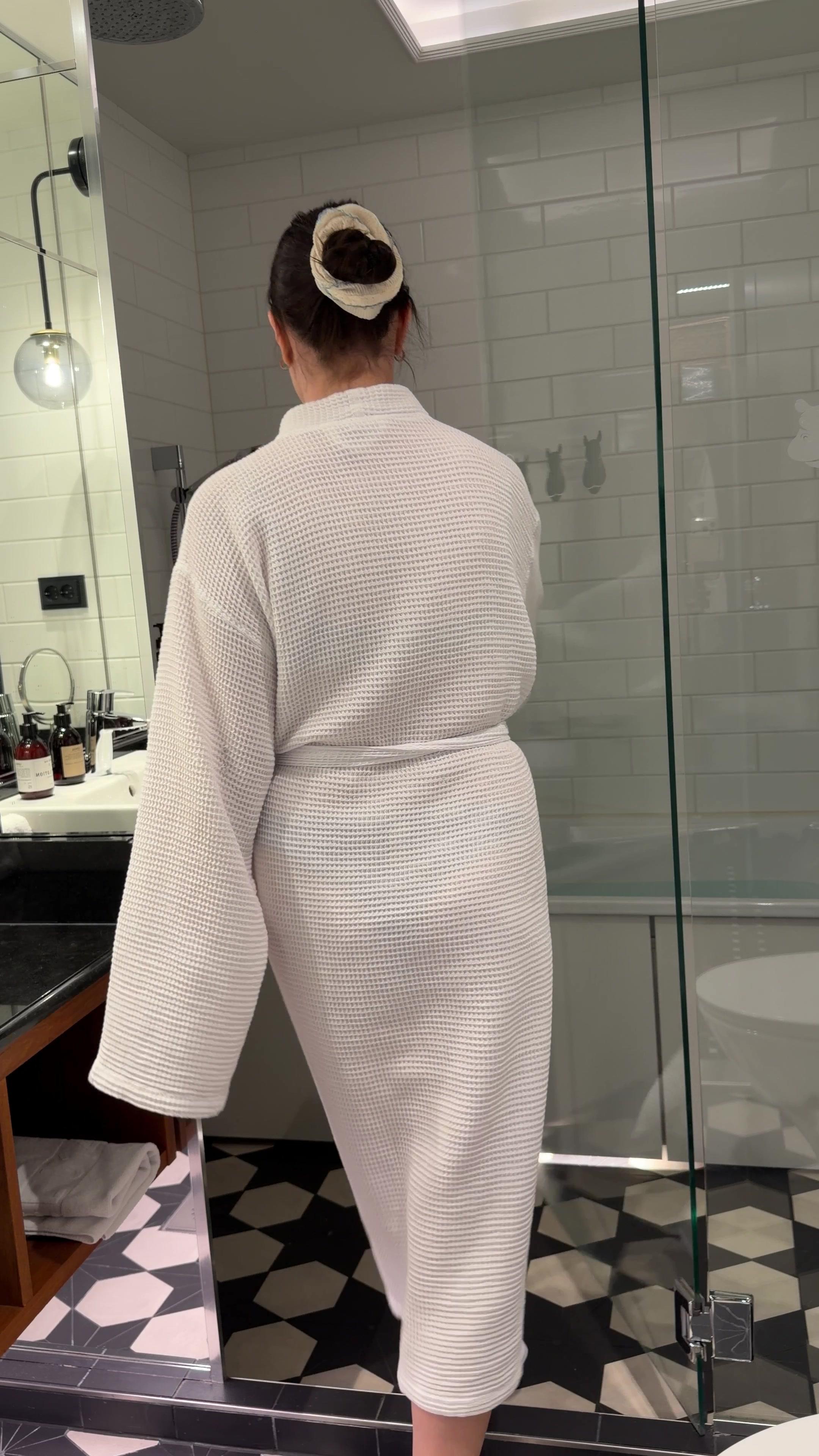 Woman in Bathrobe Running a Bath