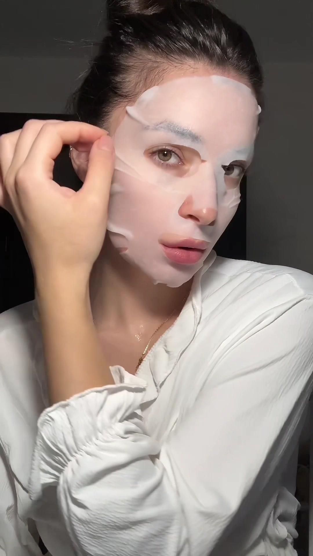Woman Peeling Off Face Sheet Mask