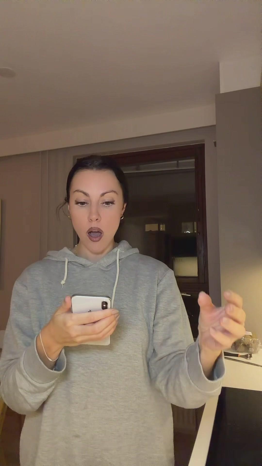 Shocked Woman Reacting to Smartphone Screen
