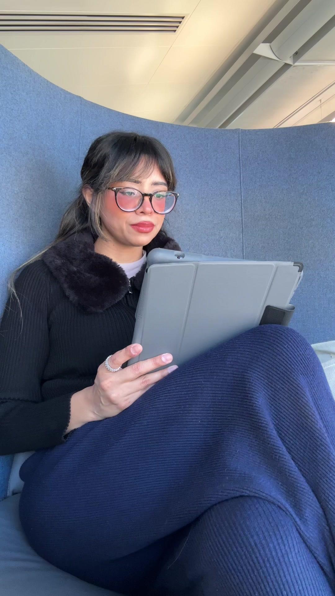 Woman Working on Tablet in Chair