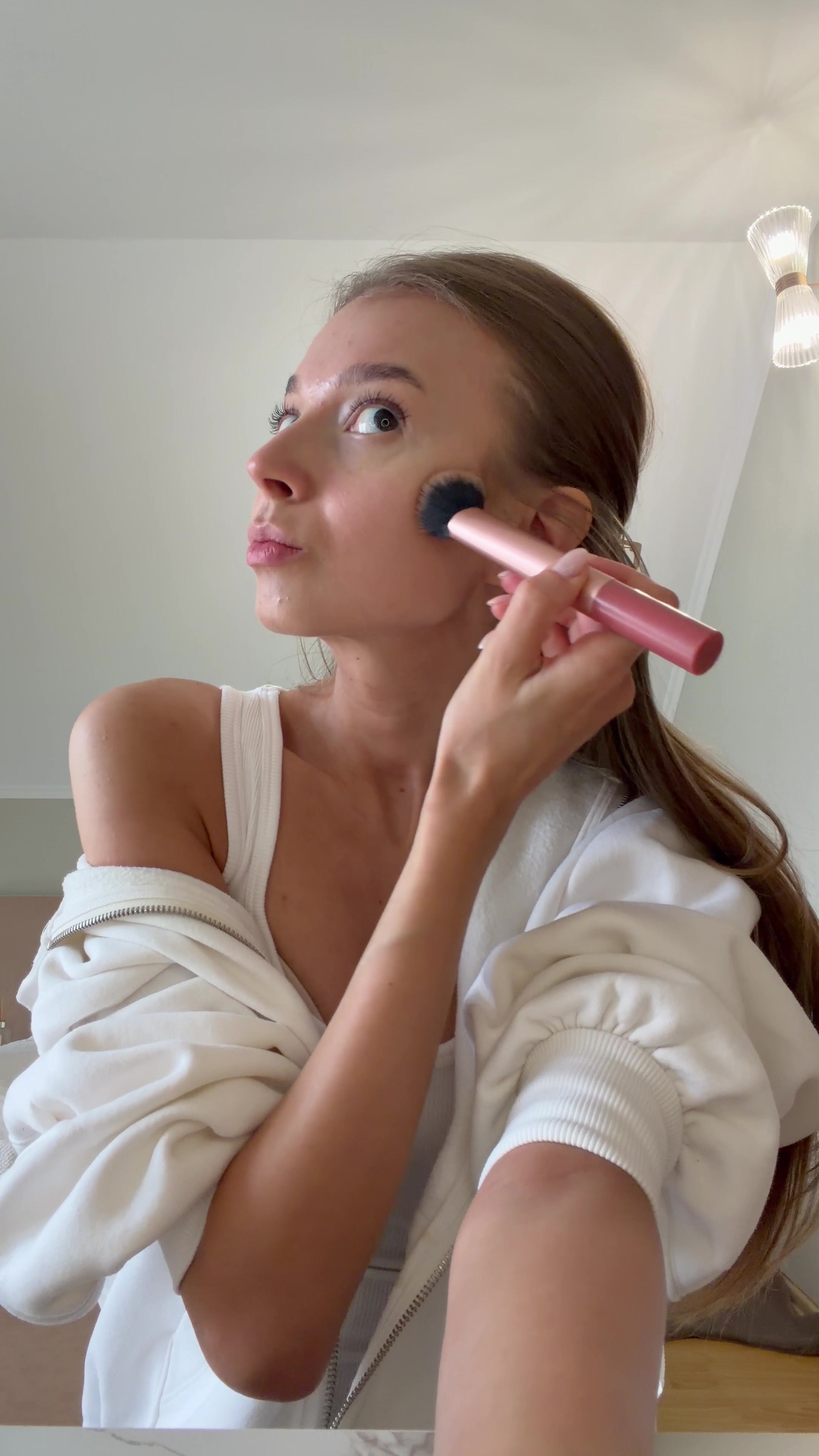 Woman Applies Makeup with Brush